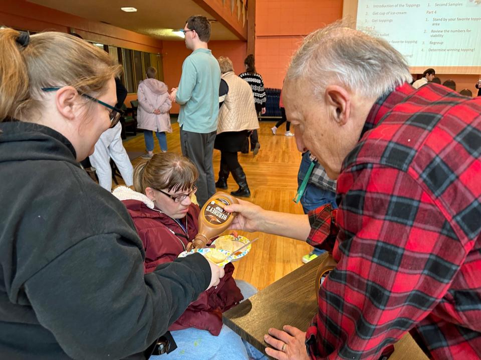 Individuals from The Arc of Story County learned about the caucus Monday as they chose from a selection of ice cream toppings. The mock caucus was led by members of the League of Women Voters of Ames & Story County.