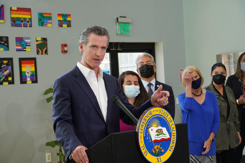 California Gov. Gavin Newsom announces new state efforts to better protect the health of communities near oil fields at a news conference at the Wilmington Boys & Girls Club in Wilmington, Calif., Thursday, Oct. 21, 2021. California's oil and gas regulator on Thursday proposed that the state ban new oil drilling within 3,200 feet of schools, homes and hospitals to protect public health in what would be the nation's largest buffer zone between oil wells and communities. (AP Photo/Eugene Garcia)