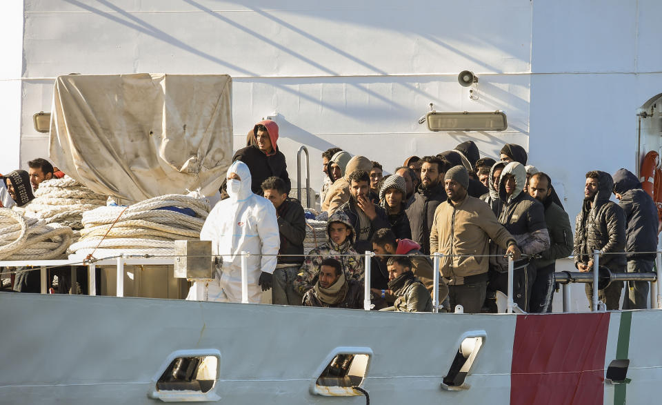 The Italian coast guard ship Peluso enters the Sicilian harbor of Catania, Italy, Monday, April 17, 2023, with some 300 migrants saved from the sea. (AP Photo/Salvatore Cavalli)