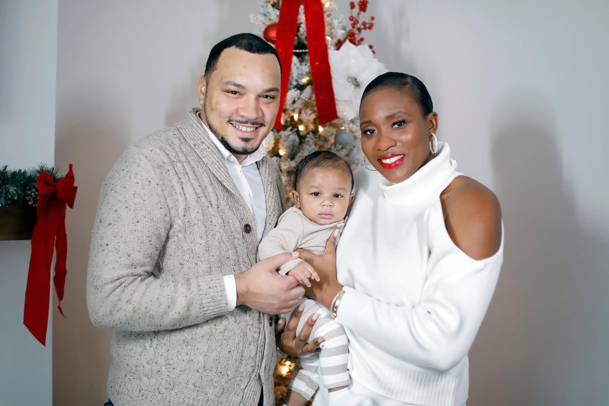 The Bankston family Nick, Habiba and 5-month-old son Xavier pose for a family photo inside their house in Columbus on December 6, 2021. Habiba lives with sickle cell disease and is speaking out to raise awareness of the need for blood donations, particularly among the Black community.  Habiba has to have monthly transfusions.