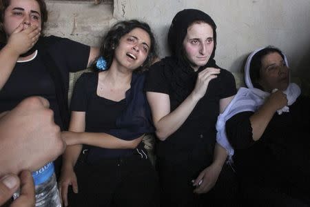 Relatives of Alawite soldier Ali Khaddaaro, who was killed during clashes between Lebanese Army soldiers and Islamist militants in Arsal, mourn during his funeral in Talhmera village, Akkar August 5, 2014. REUTERS/Stringer