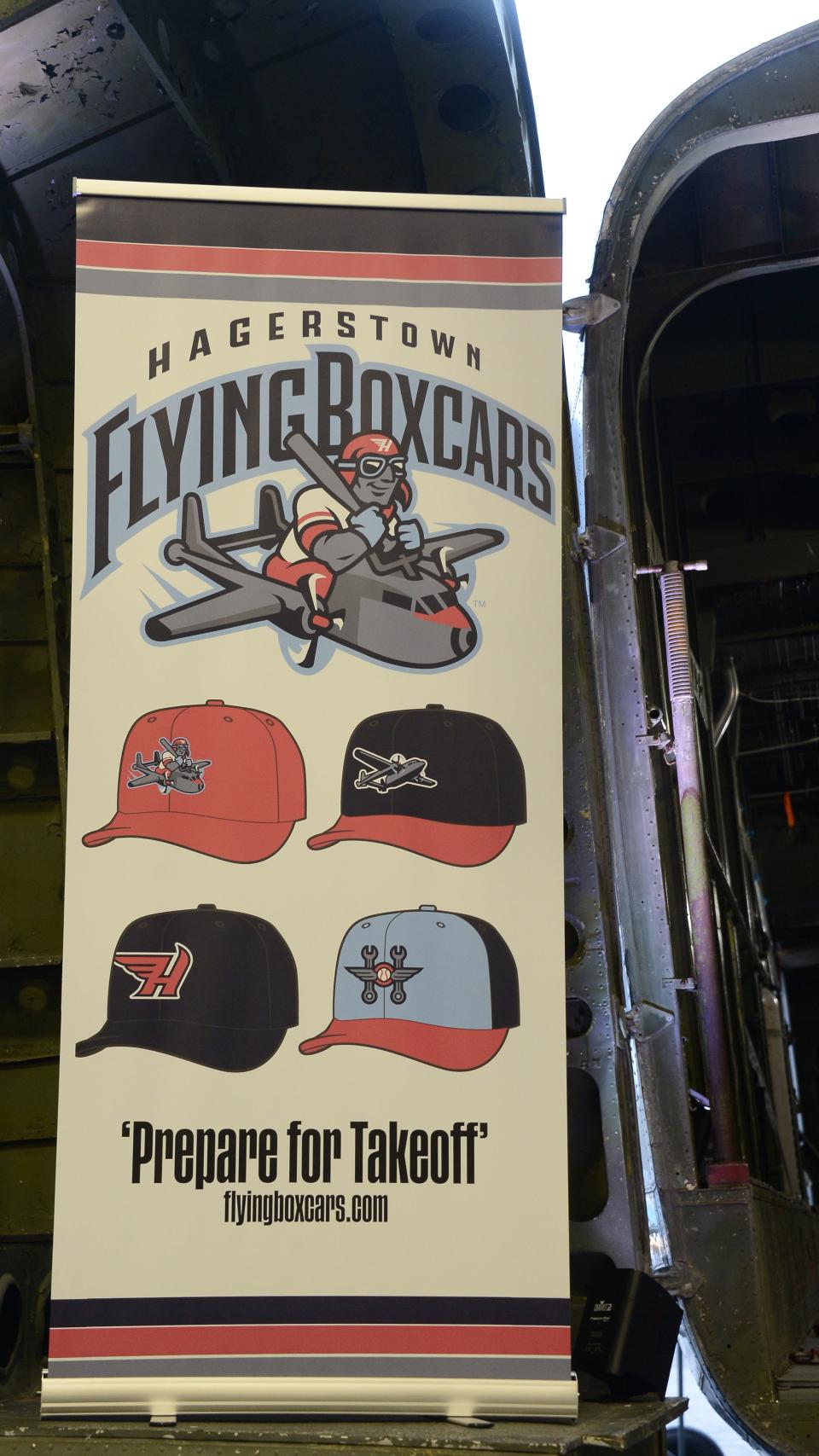 A banner showing the new logo and ballcap design for the Hagerstown Flying Boxcars sits in the door of the C-82 Packet at the Hagerstown Aviation Museum during an unveiling ceremony Wednesday night.