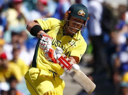 Australian batsman David Warner plays the ball for six run during his Cricket World Cup semi-final match against India in Sydney, March 26, 2015. REUTERS/David Gray