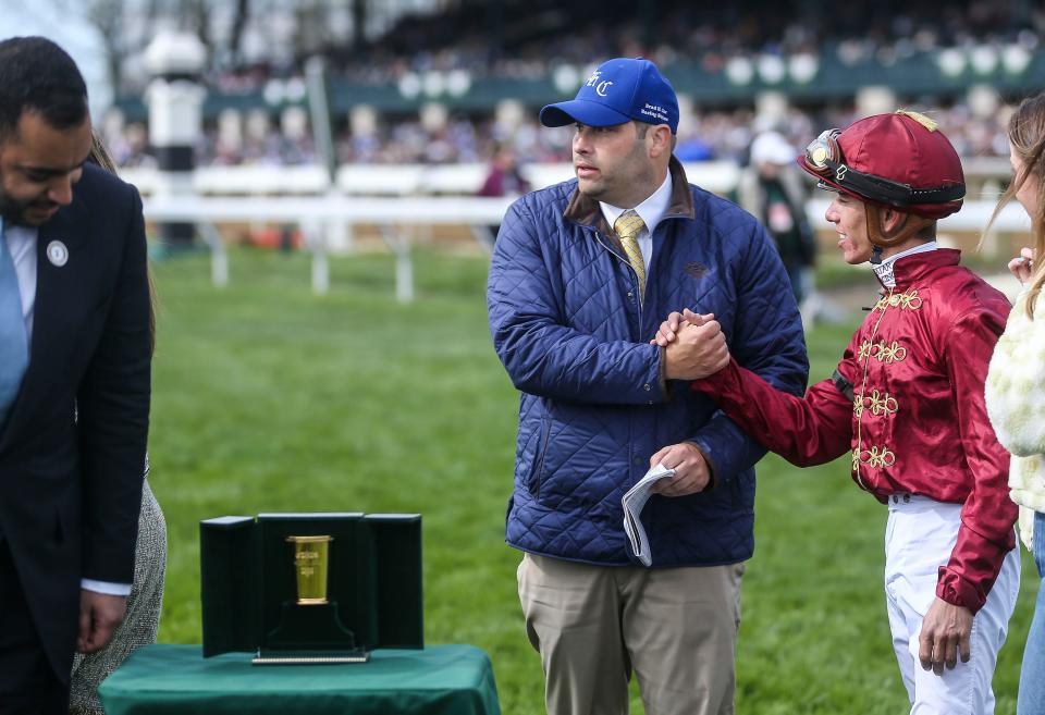 Trainer Brad Cox congratulates jockey Tyler Gaffalione after he piloted Caravel to claim the Shakertown Grade Two stakes in the eighth race at the 2023 Toyota Blue Grass Stakes Saturday at Keeneland. April 8, 2023