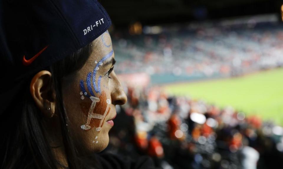 A fan watches batting practice before the game.