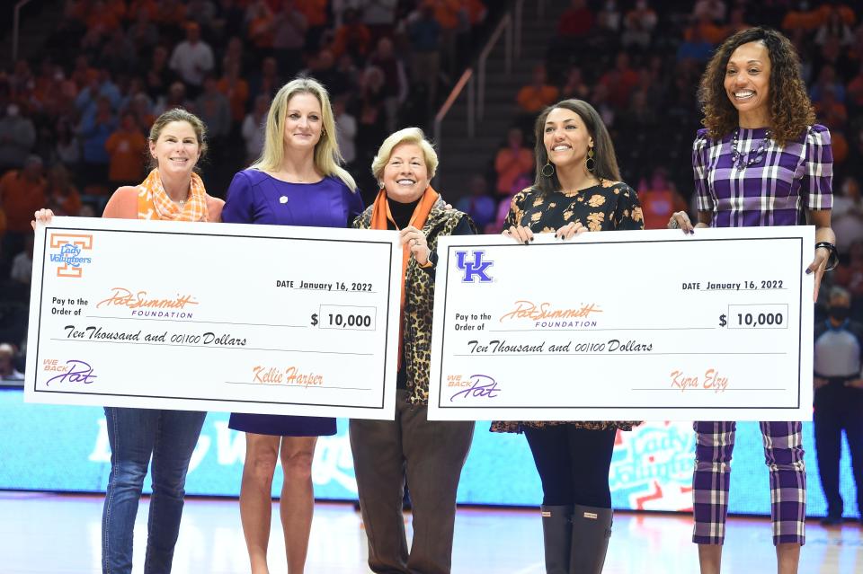 Tennessee women's basketball coach Kellie Harper left, and Kentucky women's basketball coach Kyra Elzy each presenting $10,000 checks to the Pat Summitt Foundation before the start NCAA basketball game between the Tennessee Lady Vols and Kentucky Wildcats in Knoxville, Tenn. on Sunday, January 16, 2022. At left is Pat Summitt Foundation Advisory Board member Adrian Jay, center is UT Women’s Athletics Director Emeritus and Pat Summitt Foundation Advisory Board member Joan Cronan, and Pat Summitt Foundation Director of Advancement Morgan Vance.