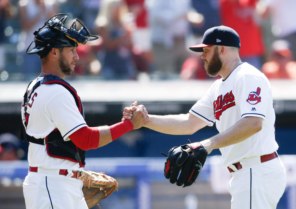 Cleveland’s Yan Gomes, left, and Cody Allen celebrate a victory over the New York Yankees in July. (AP)