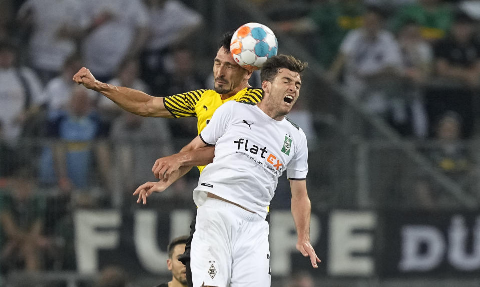 FILE - Dortmund's Mats Hummels, left, and Moenchengladbach's Joe Scally challenge for the ball during the German Bundesliga soccer match between Borussia Moenchengladbach and Borussia Dortmund in Moenchengladbach, Germany, Saturday, Sept. 25, 2021. Scally, an 18-year-old defender who has become a starter for Monchengladbach this season, was the lone first-time callup on the 25-man roster for United States' World Cup qualifiers against Mexico on Nov. 12 at Cincinnati and at Jamaica four days later. (AP Photo/Martin Meissner, File)