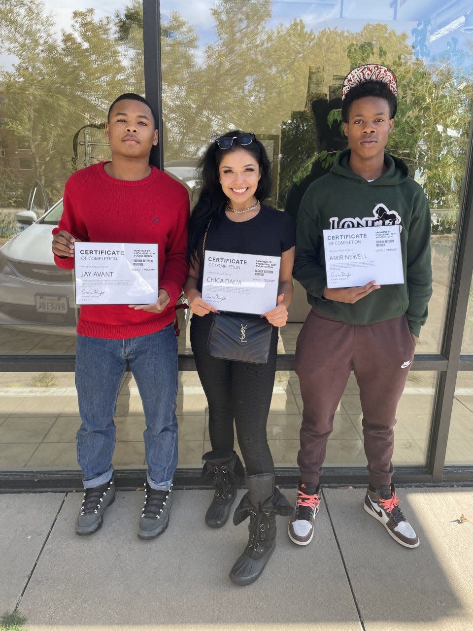 Jay Avant, Dalia Castaneda and Amir Newell hold certificates of completion for an online course from Wright House of Fashion in partnership with Warner Music Group.