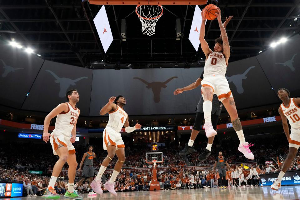 Texas forward Timmy Allen goes high to grab a rebound during the Longhorns' game against Oklahoma State on Jan. 24. "He's a great player," said Baylor coach Scott Drew after the Longhorns' 76-71 win on Monday.