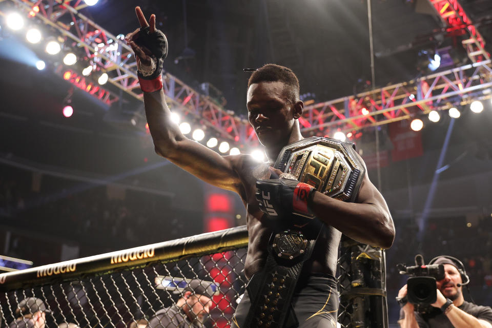 HOUSTON, TEXAS - FEBRUARY 12: Israel Adesanya of Nigeria celebrates after defending his middleweight championship against Robert Whittaker of Australia during UFC 271 at Toyota Center on February 12, 2022 in Houston, Texas. (Photo by Carmen Mandato/Getty Images)