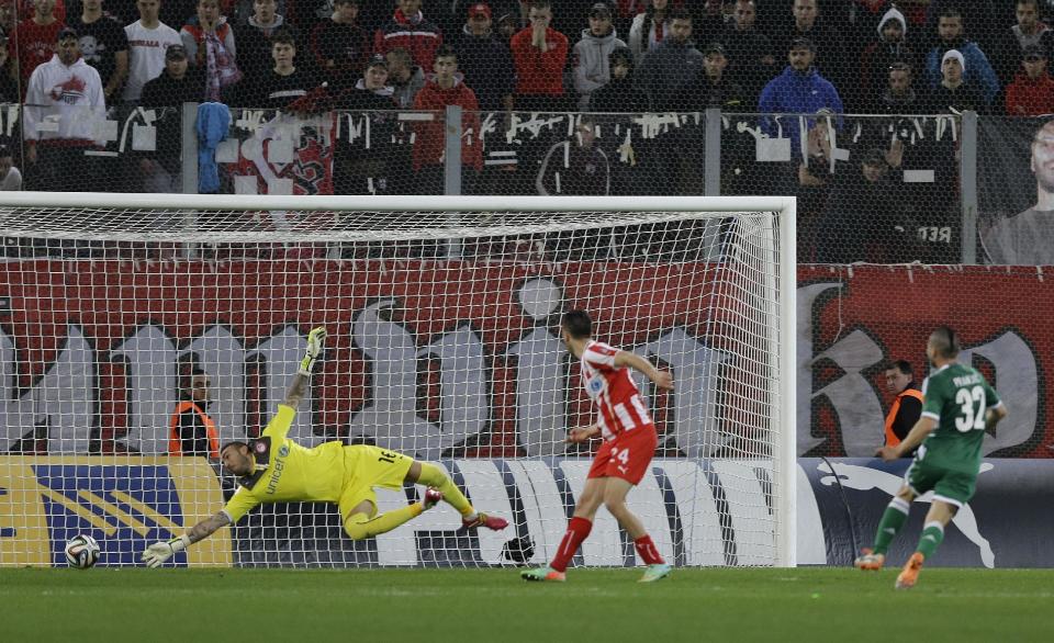 Olympiakos' goalkeeper Roberto, left, tries to save the ball as Panathinaikos' Danijel Pranjic scores the opening goal during a Greek League soccer match at Georgios Karaiskakis stadium, in Piraeus port, near Athens, on Sunday, March 2, 2014. (AP Photo/Thanassis Stavrakis)