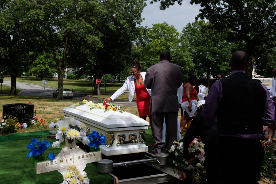 Family and friends place flowers on Jamel Floyd’s coffin.<span class="copyright">Yuki Iwamura</span>