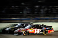 HOMESTEAD, FL - NOVEMBER 20: Tony Stewart, driver of the #14 Office Depot/Mobil 1 Chevrolet, drives alongside A.J. Allmendinger, driver of the #43 Best Buy Ford, during the NASCAR Sprint Cup Series Ford 400 at Homestead-Miami Speedway on November 20, 2011 in Homestead, Florida. (Photo by Jared C. Tilton/Getty Images)