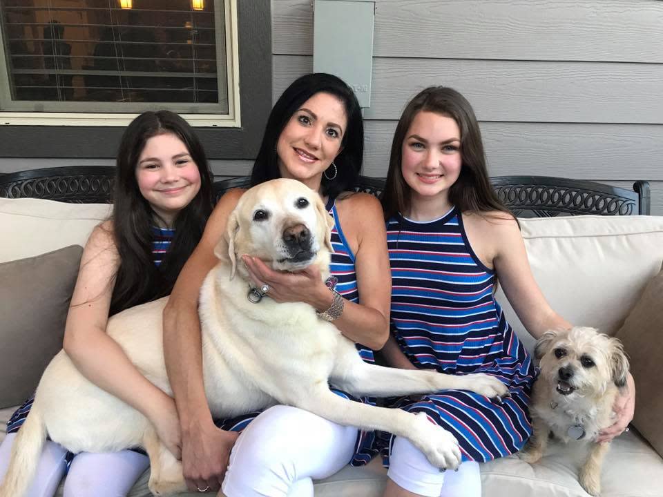 Joy Ross is pictured with her guide dog, Antonia, on her lap, and her two daughters, Isabella and Giorgianna, along with their other dog, Lily. (Photo: Courtesy of Courtney Leiva)