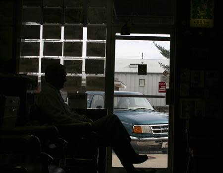 Ray Sanford awaits a haircut in a barbershop in downtown Rogers, Arkansas, December 4, 2013. REUTERS/Andy Sullivan