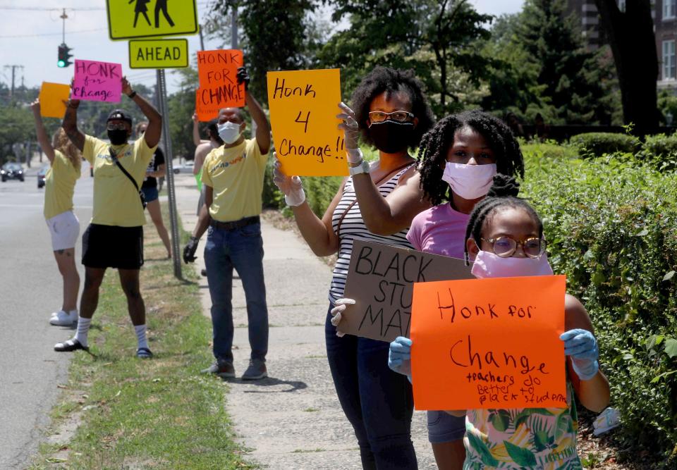 In this 2020 file photo, Lorraine Martin and her daughters are shown among a group of people protesting outside Mamaroneck High School on June 29, 2020. The group One Mamaroneck, called for changes in the Mamaroneck school district's administration, including the resignation of school's superintendent, Dr. Robert Shaps. The group called for changes due to the lack response to alleged incidents of racism in the schools. Martin said that she took her daughters out of the Mamaroneck schools after one of then was referred to by a racist term, and they were both made to feel unwelcome because of their skin color. Several protestors plan to camp out on high school property until changes they seek are made.