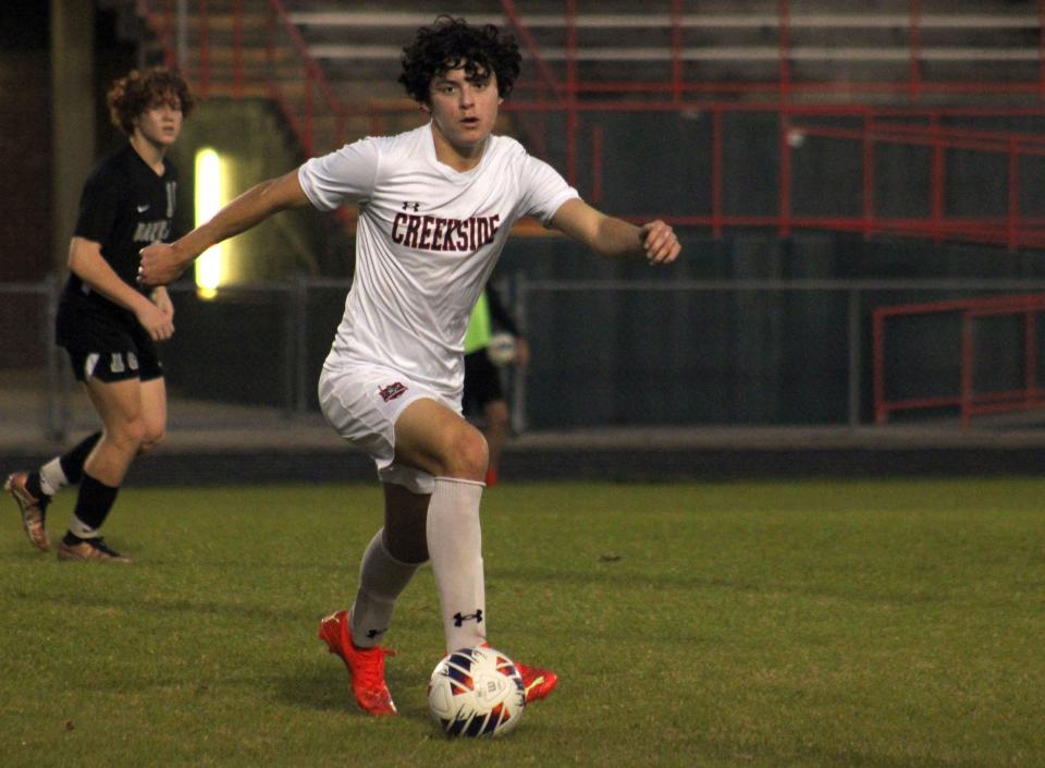 Creekside's Christian Denegri advances the ball in the Knights' midfield.