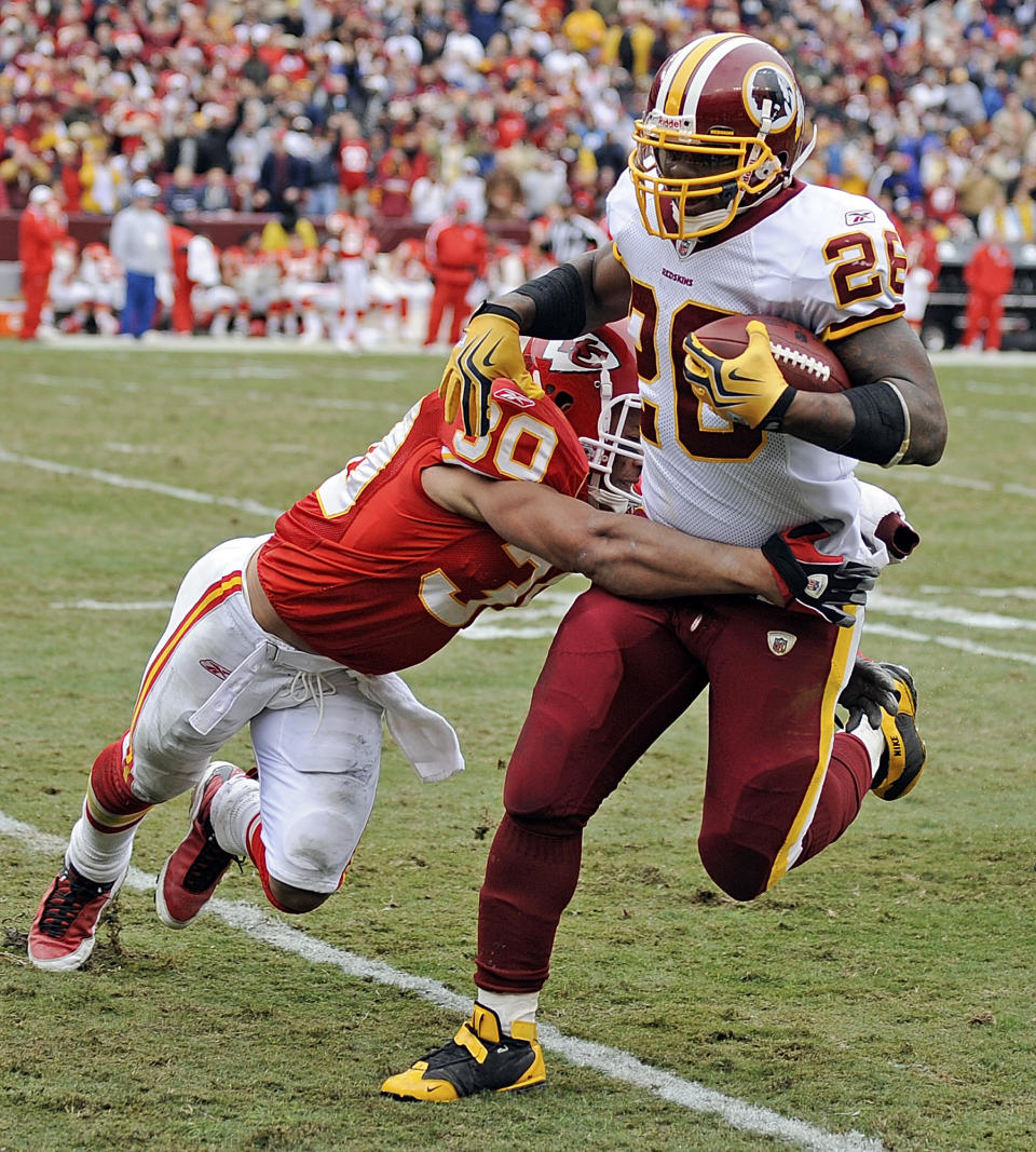 Washington Redskins running back Clinton Portis, right, carries the ball as Kansas City Chiefs safety Mike Brown closes in during the fourth quarter of an NFL football game , Sunday, Oct. 18, 2009, in Landover, Md. Kansas City won 14-6. (AP Photo/Nick Wass)