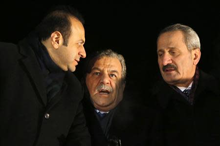 Turkey's European Affairs Minister Egemen Bagis (L), Interior Minister Muammer Guler and Economy Minister Zafer Caglayan (R) chat as they wait for the arrival of Prime Minister Tayyip Erdogan at Esenboga Airport in Ankara in this December 24, 2013 file photo. REUTERS/Umit Bektas/Files