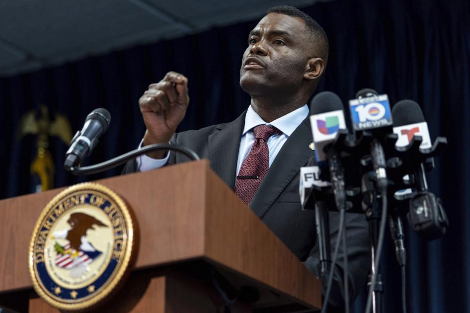 United States Attorney Markenzy Lapointe speaks to the media about a network of nursing school operators, centered in South Florida, who allowed students to buy diplomas without the proper training as representatives from FBI Miami and Department of Health and Human Services Office of Inspector General (HHS-OIG), Miami Regional Office stand behind him during a press conference at the U.S. Attorney's Office for the Southern District of Florida in Downtown Miami on Wednesday, Jan. 25, 2023. (D.A. Varela/Miami Herald via AP)