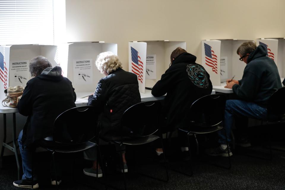 People vote during the first day of early voting at the Polk County Auditor’s Office in downtown Des Moines on Wednesday, Oct. 19, 2022. Today was the first day of early voting in the 2022 election for Polk County voters.