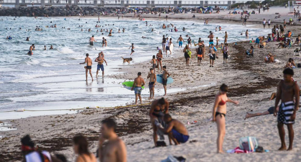 Pictured are hundreds of people on Miami Beach amid the coronavirus pandemic. 