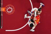 <p>Spain's Laura Gil (in red) fights for the ball with South Korean players in the women's preliminary round group A basketball match between South Korea and Spain during the Tokyo 2020 Olympic Games at the Saitama Super Arena in Saitama on July 26, 2021. (Photo by Brian SNYDER / various sources / AFP)</p> 