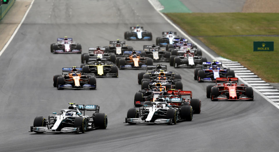 Mercedes drivers Valtteri Bottas and Lewis Hamilton at the first corner during the British Grand Prix at Silverstone, Towcester. (Photo by Martin Rickett/PA Images via Getty Images)