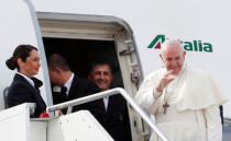 Pope Francis waves as he boards a plane before departure for his visit to United Arabs Emirates, at Leonardo da Vinci-Fiumicino Airport in Rome, Italy, February 3, 2019. REUTERS/Remo Casilli