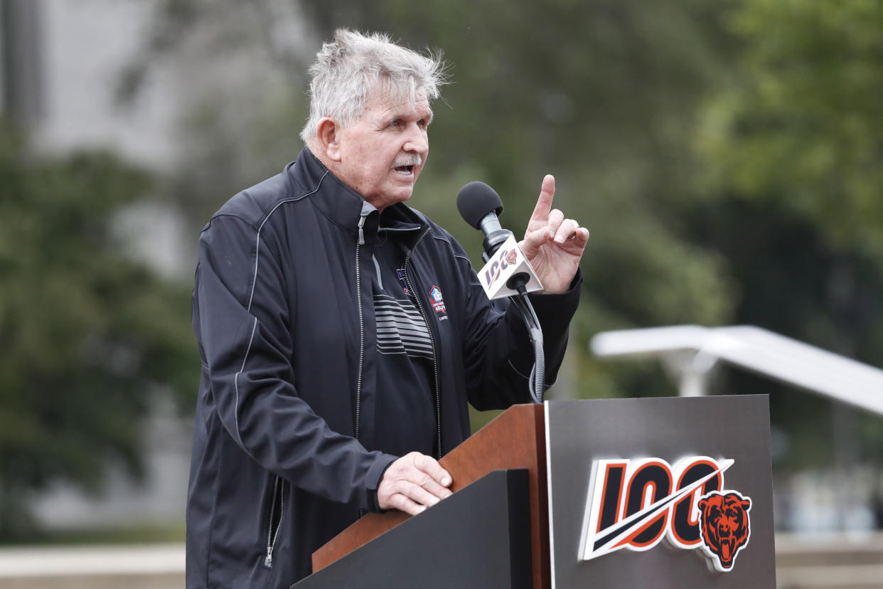 Pro Football Hall of Fame coach Mike Ditka at a podium with &quot;100&quot; and the Chicago Bears logo. 