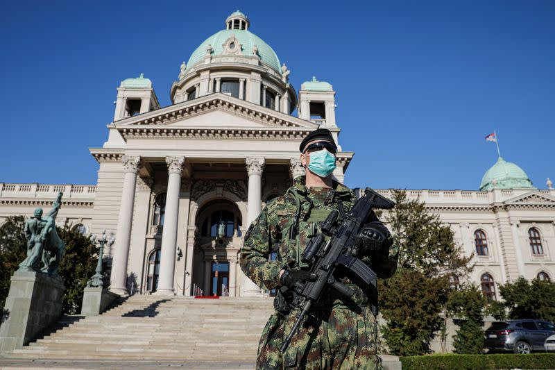 A Serbian army soldier patrols in front of the Parliament building in Belgrade