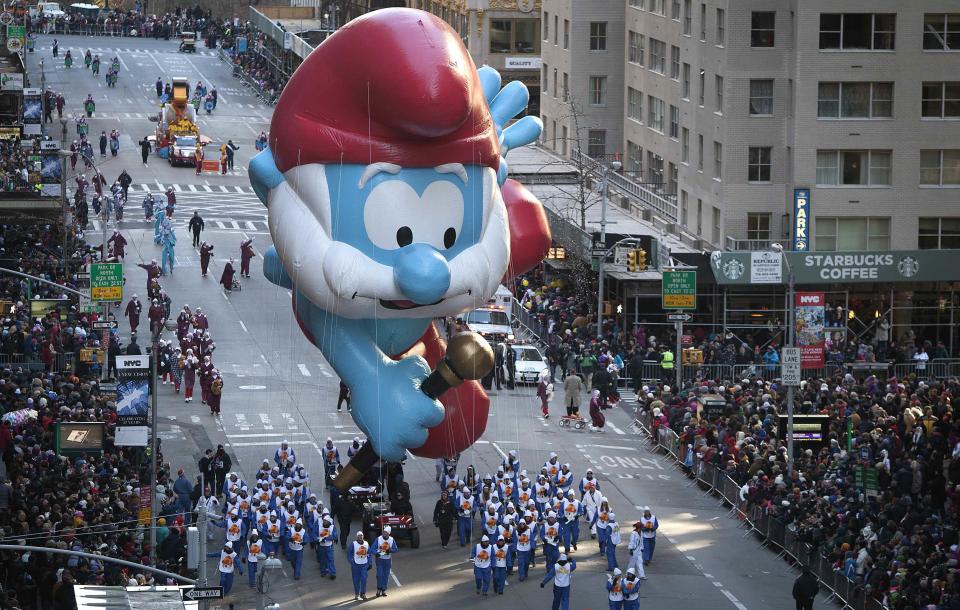 A Papa Smurf float makes its way down 6th Ave. during the 87th Macy's Thanksgiving day parade in New York November 28, 2013. REUTERS/Carlo Allegri (UNITED STATES - Tags: ENTERTAINMENT BUSINESS SOCIETY)