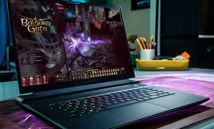 An Alienware m16 gaming laptop in use on a desk, playing Baldur's Gate III.