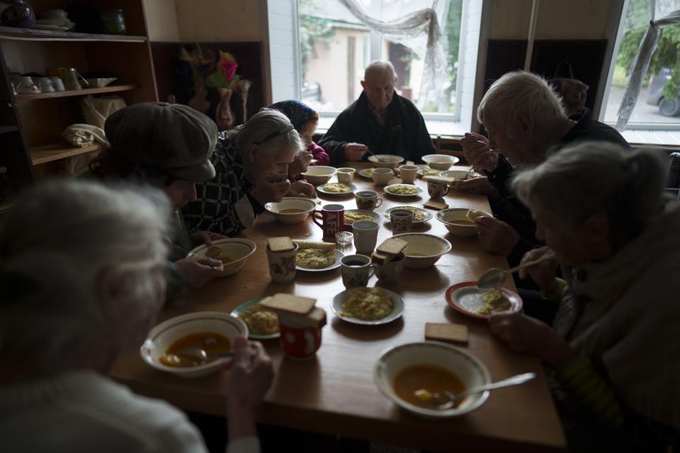 Patients eat a meal in a shelter for injured and homeless people in Izium, Ukraine, Monday, Sept. 26, 2022. The image was part of a series of images by Associated Press photographers that was a finalist for the 2023 Pulitzer Prize for Feature Photography. (AP Photo/Evgeniy Maloletka)