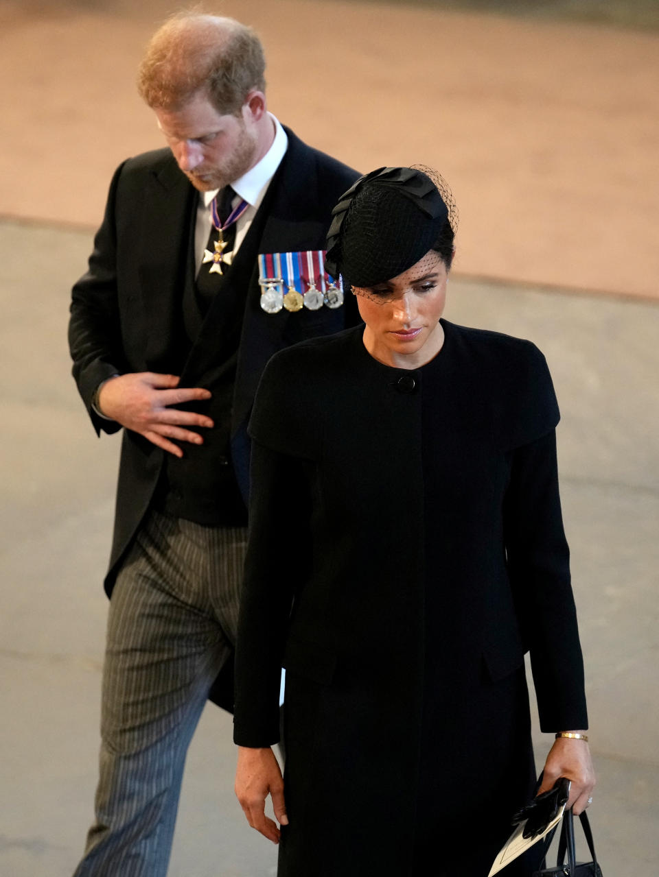 <p>LONDON, ENGLAND - SEPTEMBER 14: Prince Harry, Duke of Sussex and Meghan, Duchess of Sussex pay their respects at The Palace of Westminster during the procession for the Lying-in State of Queen Elizabeth II on September 14, 2022 in London, England. Christopher Furlong/Pool via REUTERS</p> 