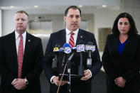 John R. Lausch Jr., U.S. Attorney for the Northern District of Illinois, center, briefs reporters on the trial of Floyd Brown in the killing of Special Deputy United States Marshal Jacob Keltner on Wednesday, March 20, 2019, U.S. District Courthouse in Rockford. Brown pleaded not guilty Wednesday to federal charges accusing him of fatally shooting Keltner, who was trying to serve an arrest warrant at a hotel. (Scott P. Yates/Rockford Register Star via AP)