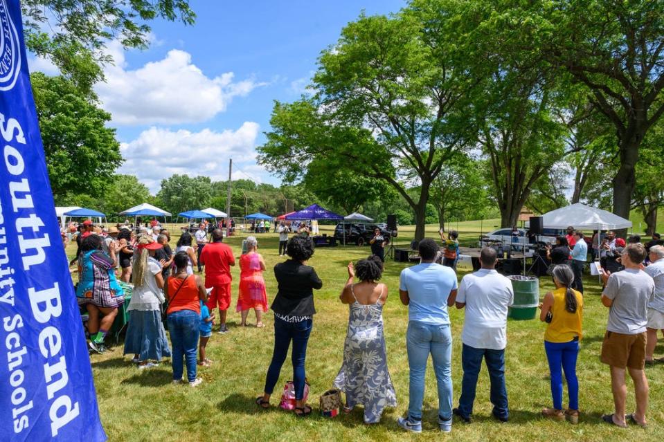 Visitors gather for opening remarks at the Juneteenth celebration at LaSalle Park in South Bend on Saturday.