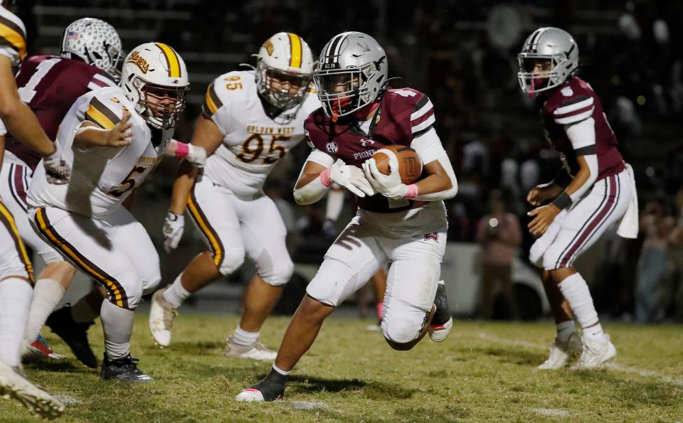 Mt. Whitney's Kysen Sing Galvizo on a run against Golden West during their high school football game at Mineral King Bowl in Visalia, Calif., Friday, Oct. 6, 2023.