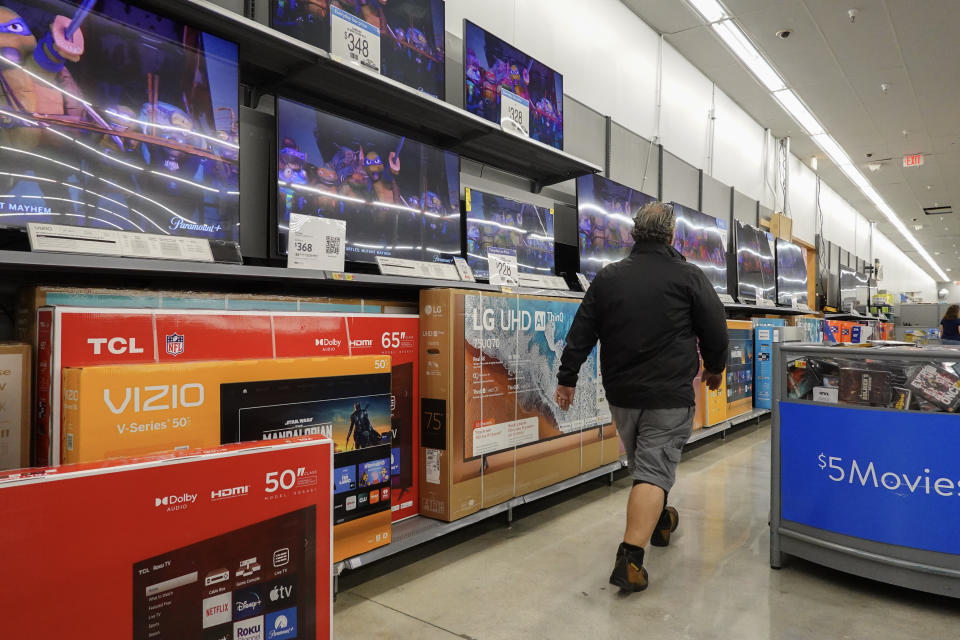 HALLANDALE BEACH, FLORIDA - FEBRUARY 20: A customer walks past televisions, including the Vizio brand, on display in a Walmart Supercenter on February 20, 2024, in Hallandale Beach, Florida. Walmart reported that quarterly revenue rose 6%, and that the company’s global e-commerce sales have also grown. Walmart also said that it agreed to purchase TV maker Vizio for $2.3 billion. (Photo by Joe Raedle/Getty Images)