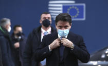 FILE - In this Thursday, Dec. 10, 2020 file photo, Italy's Prime Minister Giuseppe Conte arrives for an EU summit at the European Council building in Brussels. When Giuseppe Conte exited the premier’s office, palace employees warmly applauded in him appreciation. But that’s hardly likely to be Conte’s last hurrah in politics. Just a few hours after the handover-ceremony to transfer power to Mario Draghi, the former European Central Bank chief now tasked with leading Italy in the pandemic, Conte dashed off a thank-you note to citizens that sounded more like an ’’arrivederci″ (see you again) then a retreat from the political world he was unexpectedly propelled into in 2018. (Yves Herman, Pool via AP)