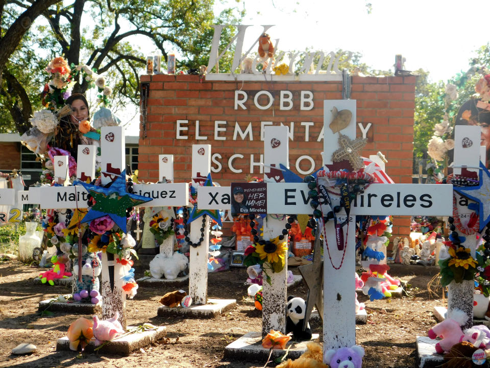 A memorial for the 19 children and two teachers killed in the May shooting sits outside of Robb Elementary on the first day of early voting, Monday, Oct. 24, 2022, in Uvalde, Texas. The Uvalde school massacre has cast a long shadow in the midterm elections in Texas, intensifying Republican Gov. Greg Abbott’s reelection fight against Democrat Beto O’Rourke and driving a blitz of television ads. (AP Photo/Acacia Coronado)