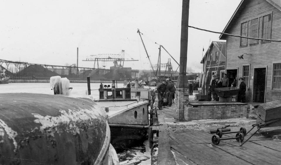 Fishing boats and fishermen are near a fishing shanty in Sheboygan in this undated photo. The C. Reiss Coal piles can be seen in the background at left.