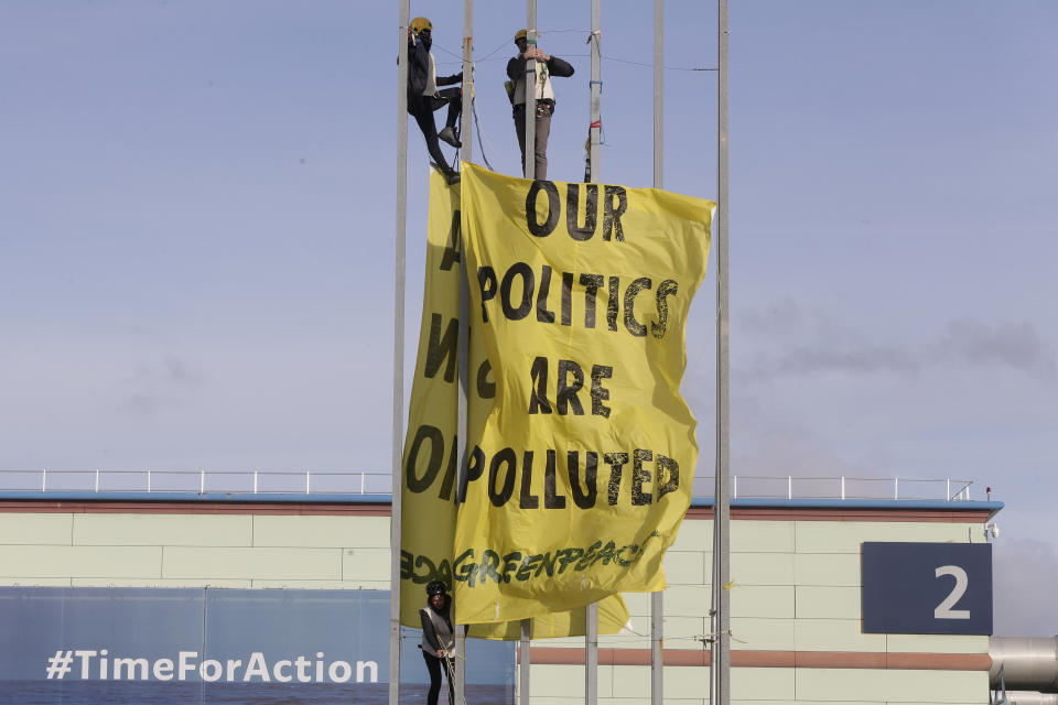 Greenpeace activists display a banner outside the COP25 climate talks congress in Madrid, Spain, Friday, Dec. 13, 2019. The United Nations Secretary-General has warned that failure to tackle global warming could result in economic disaster. (AP Photo/Paul White)