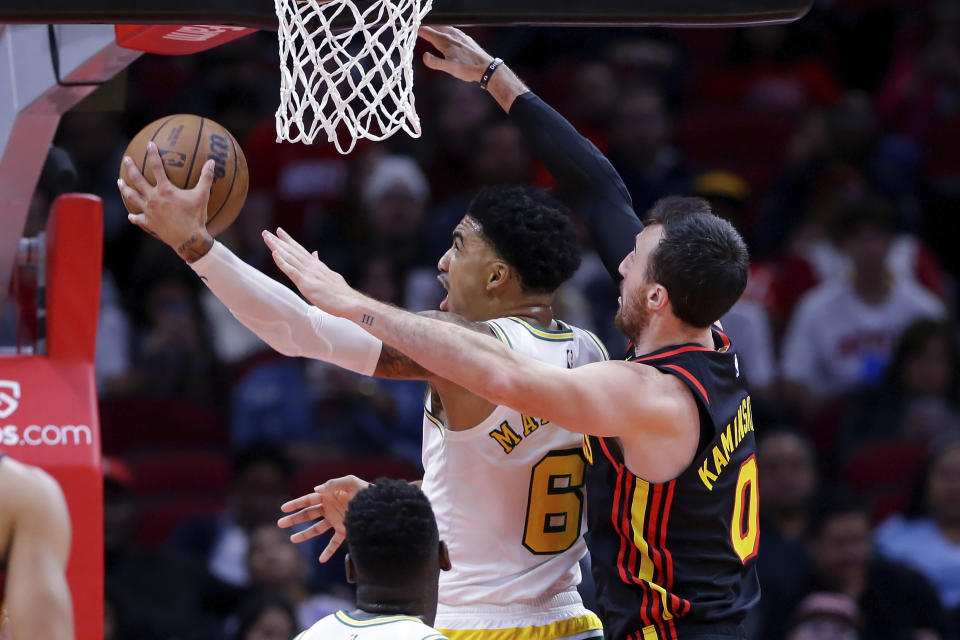 Houston Rockets forward K.J. Martin (6) lays up a shot in front of Atlanta Hawks forward Frank Kaminsky (0) during the first half of an NBA basketball game Friday, Nov. 25, 2022, in Houston. (AP Photo/Michael Wyke)