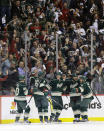 Minnesota Wild defenseman Ryan Suter (20), center Mikko Koivu (9), of Finland, center Charlie Coyle, center, right wing Jason Pominville (29) and left wing Zach Parise (11) celebrate Coyle's goal off Colorado Avalanche goalie Semyon Varlamov during the second period of Game 4 of an NHL hockey first-round playoff series in St. Paul, Minn., Thursday, April 24, 2014. The Wild won 2-1. (AP Photo/Ann Heisenfelt)