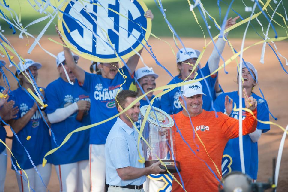 Florida Gators head coach Tim Walton accepts the championship trophy during the SEC softball tournament championship game at Jane B. Moore Field in Auburn, Ala., on Saturday, May 11, 2024. Florida Gators defeated Missouri Tigers 6-1.