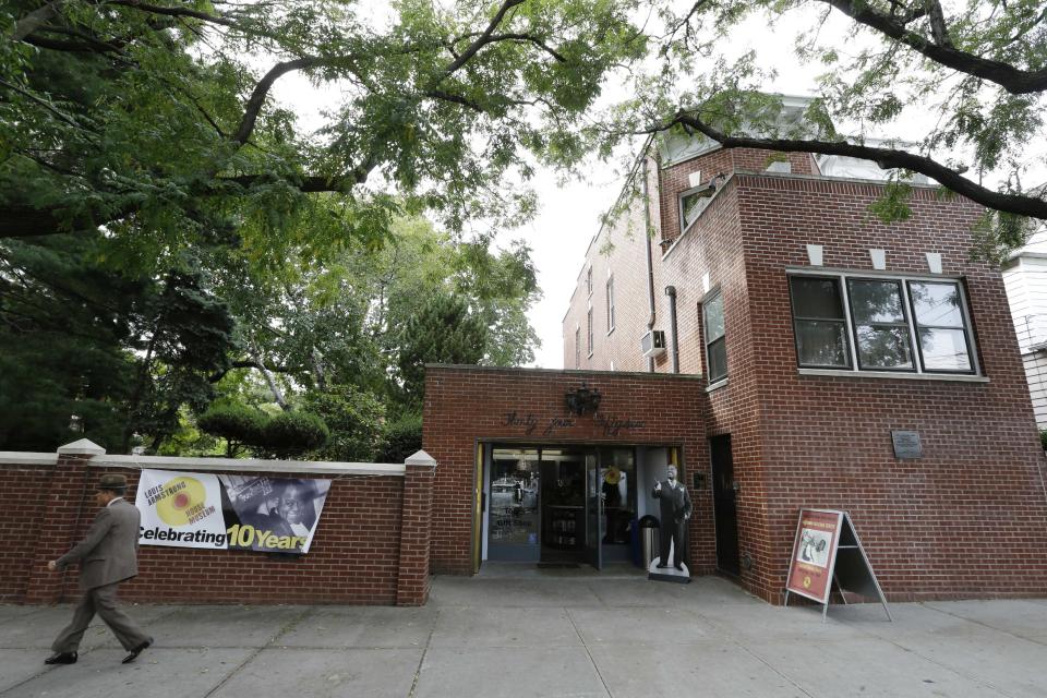 A pedestrian passes the Louis Armstrong House Museum Wednesday, Oct. 9, 2013, in the Queens borough of New York. (AP Photo/Frank Franklin II)