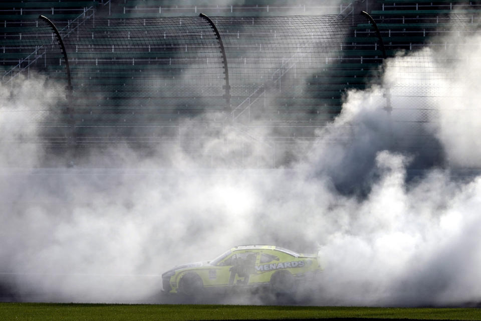 Brandon Jones does a burnout after winning a NASCAR Xfinity Series auto race at Kansas Speedway in Kansas City, Kan., Saturday, July 25, 2020. (AP Photo/Charlie Riedel)