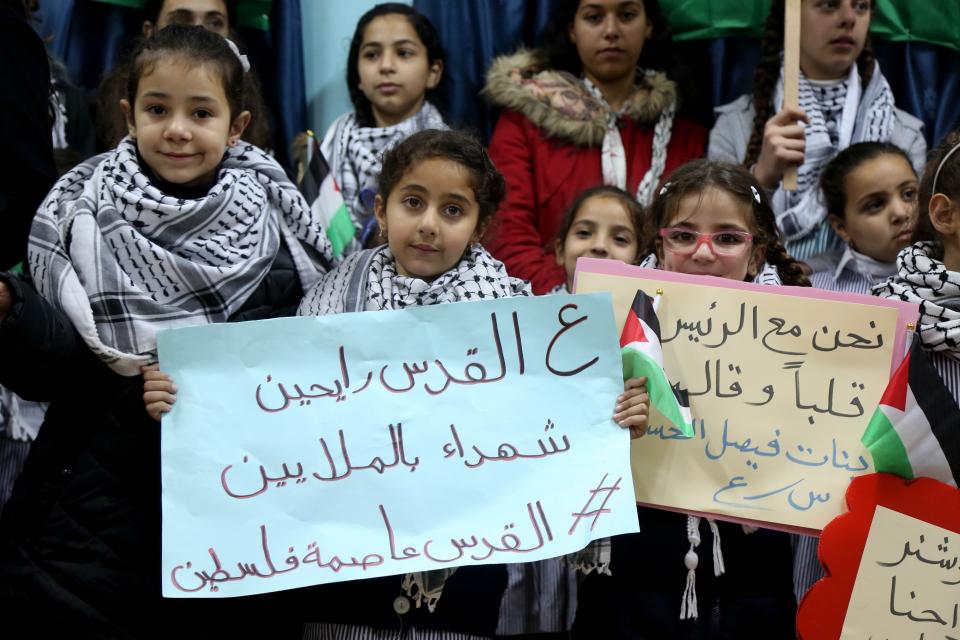 <p>Students hold placards as they protest the US President Donald Trump’s intention to recognize Jerusalem as Israels capital, at Faisal Husseini school in Ramallah, West Bank on Dec. 6, 2017. (Photo: Issam Rimawi/Anadolu Agency/Getty Images) </p>